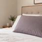 Grounding pillowcase with UK plug on bed